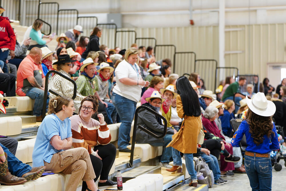 Kids and chaperones sitting in the stands watching the exceptional needs rodeo.
